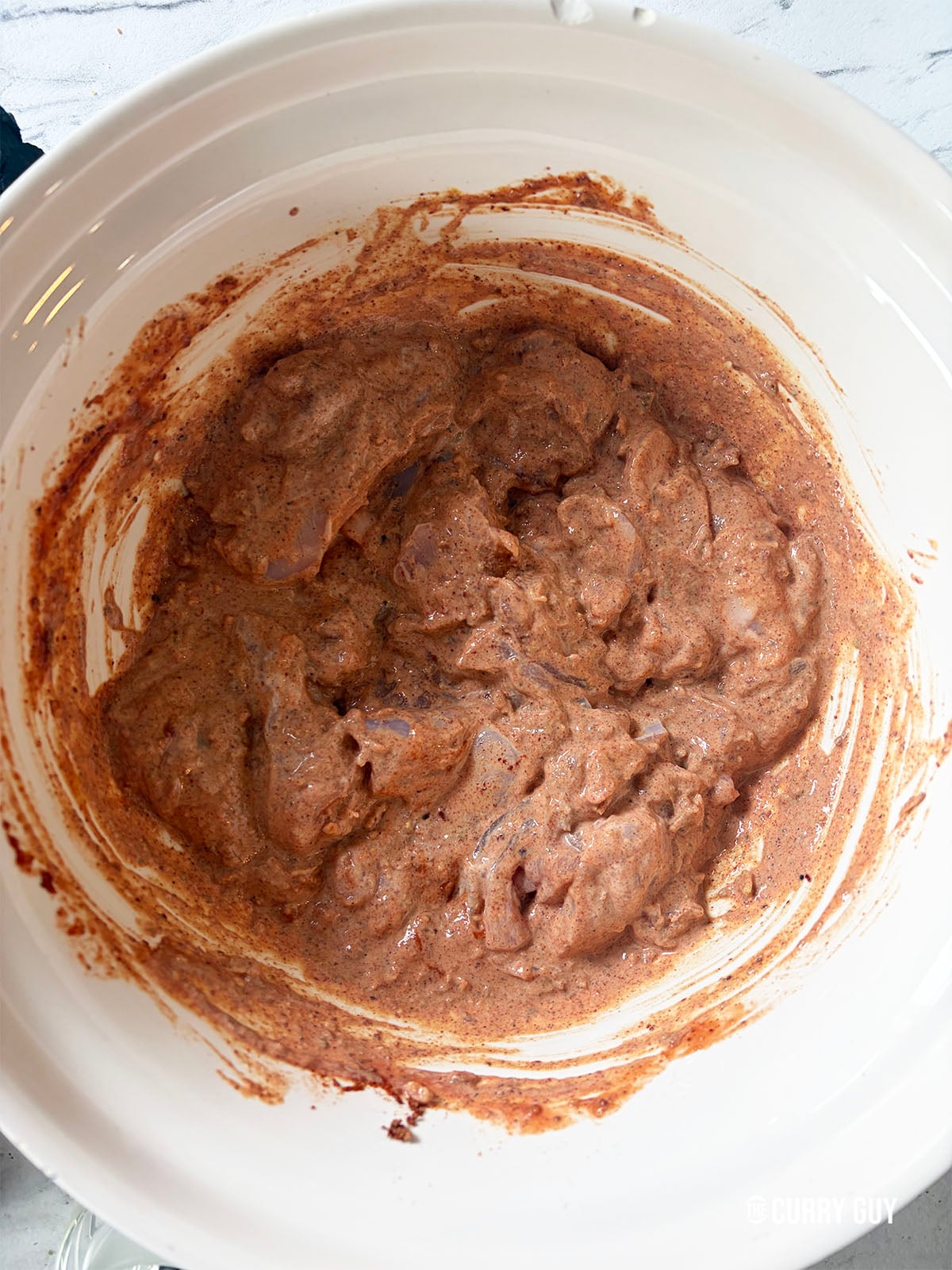 Adding the chicken angara marinade
