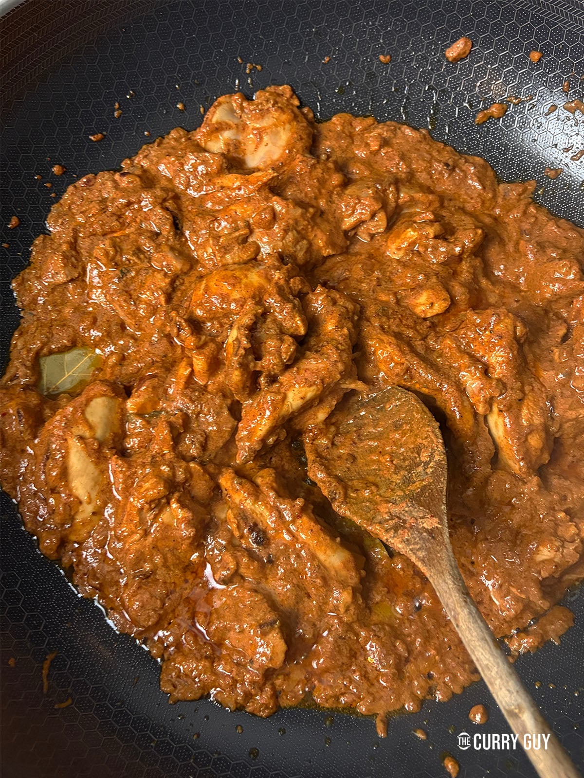 Adding the chicken and the marinade to the pan