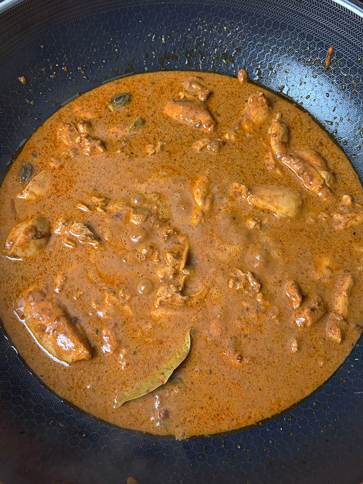 Adding the liquid to the chicken angara curry