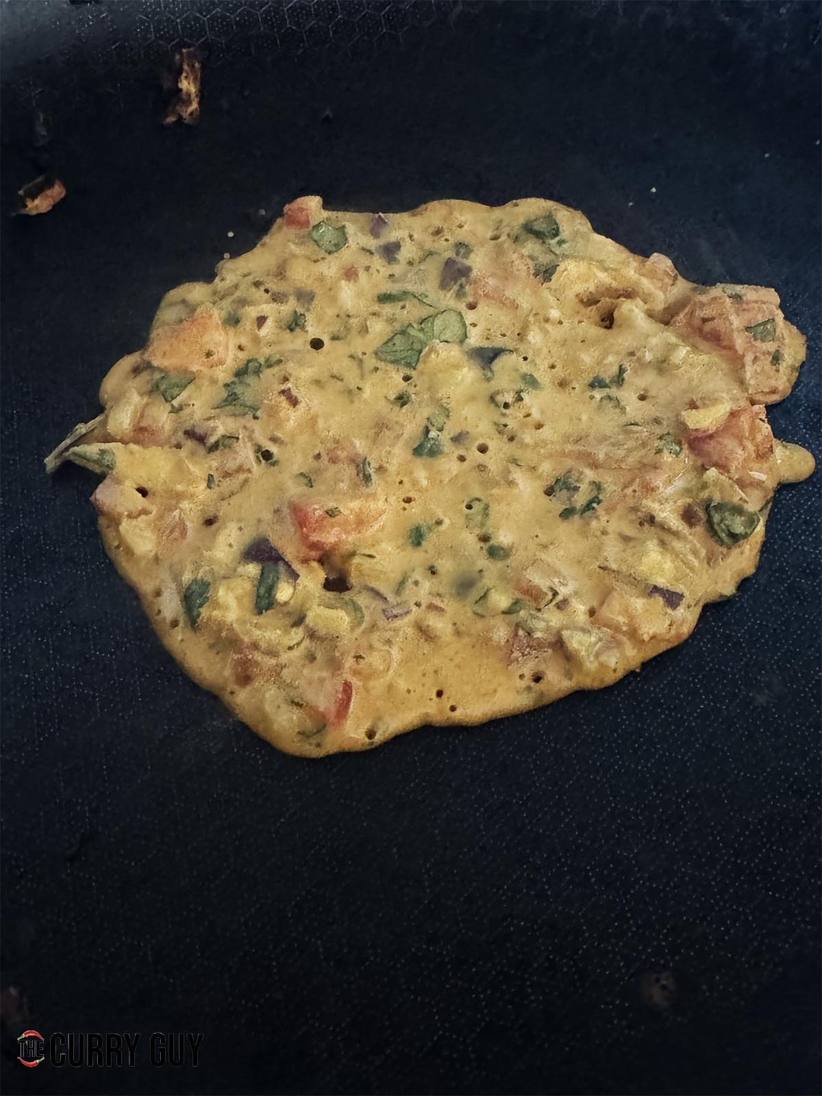 Pouring the batter into a medium hot pan to cook the underside.
