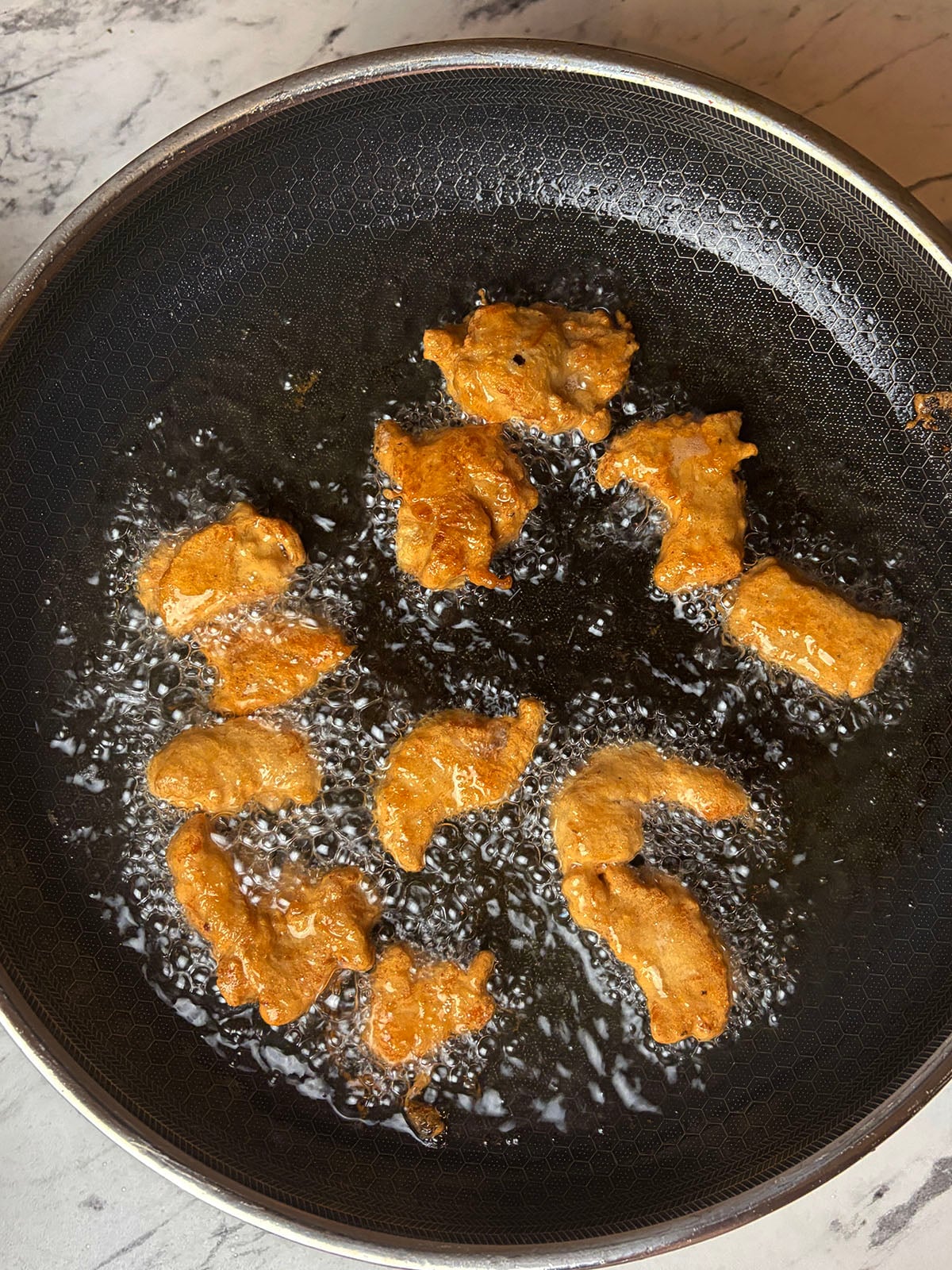 Frying the chilli chicken in batches