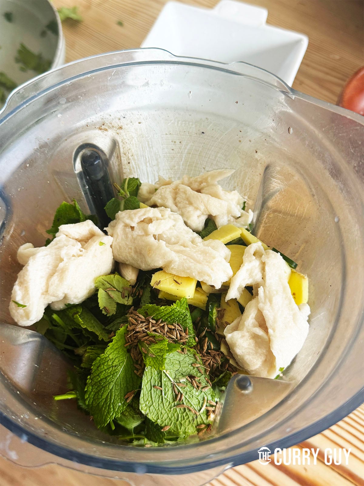 adding ingredients for Coriander, Mint and Chilli Chutney to the blender
