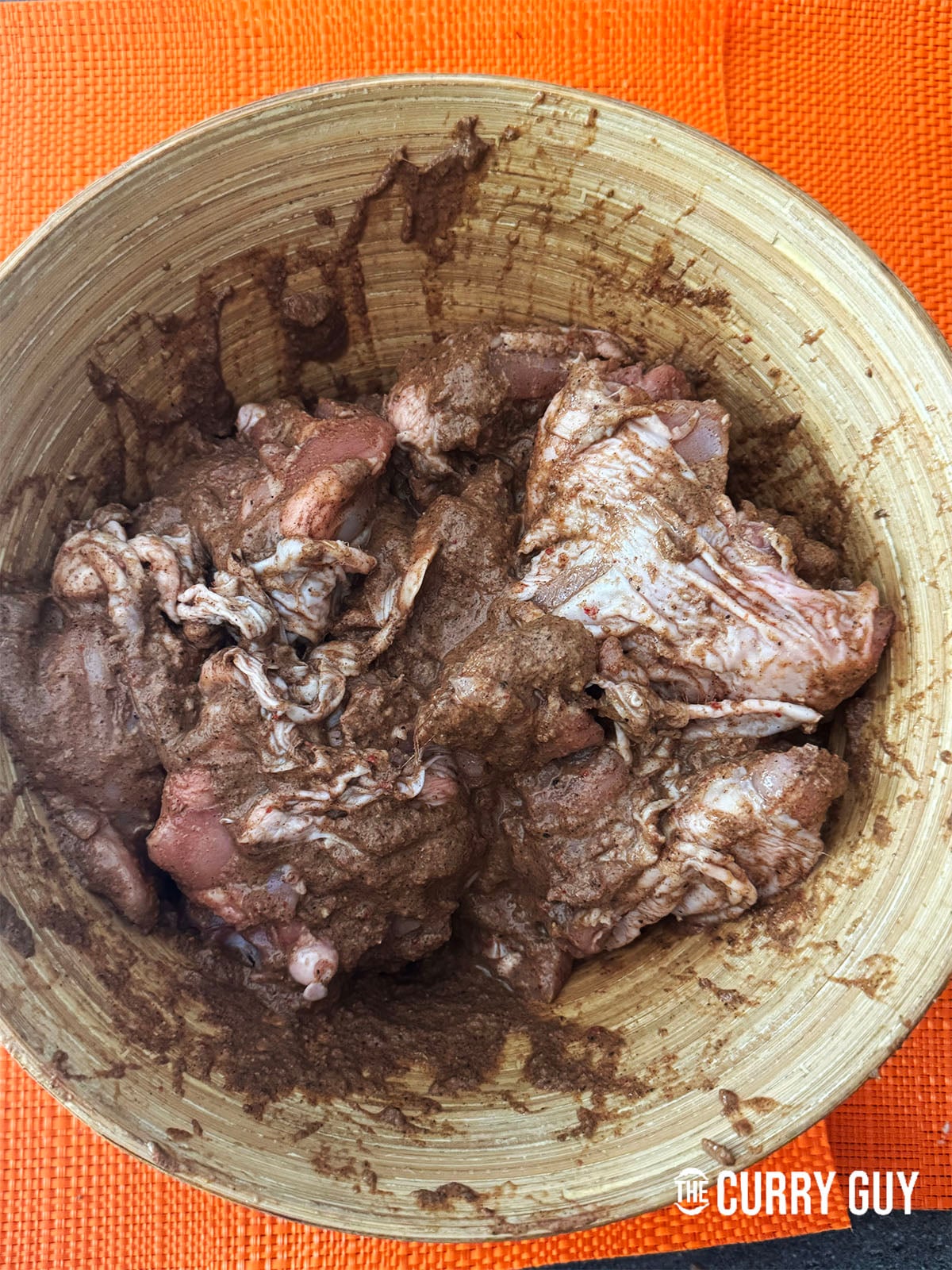 rubbing the jerk marinade on the chicken
